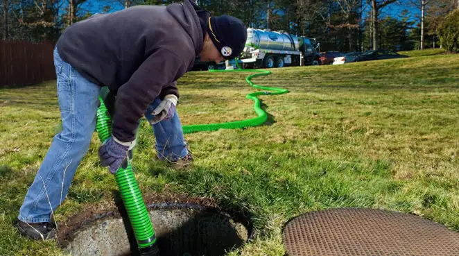 Service technician performing residential septic pumping and drainage maintenance in Irvine, CA